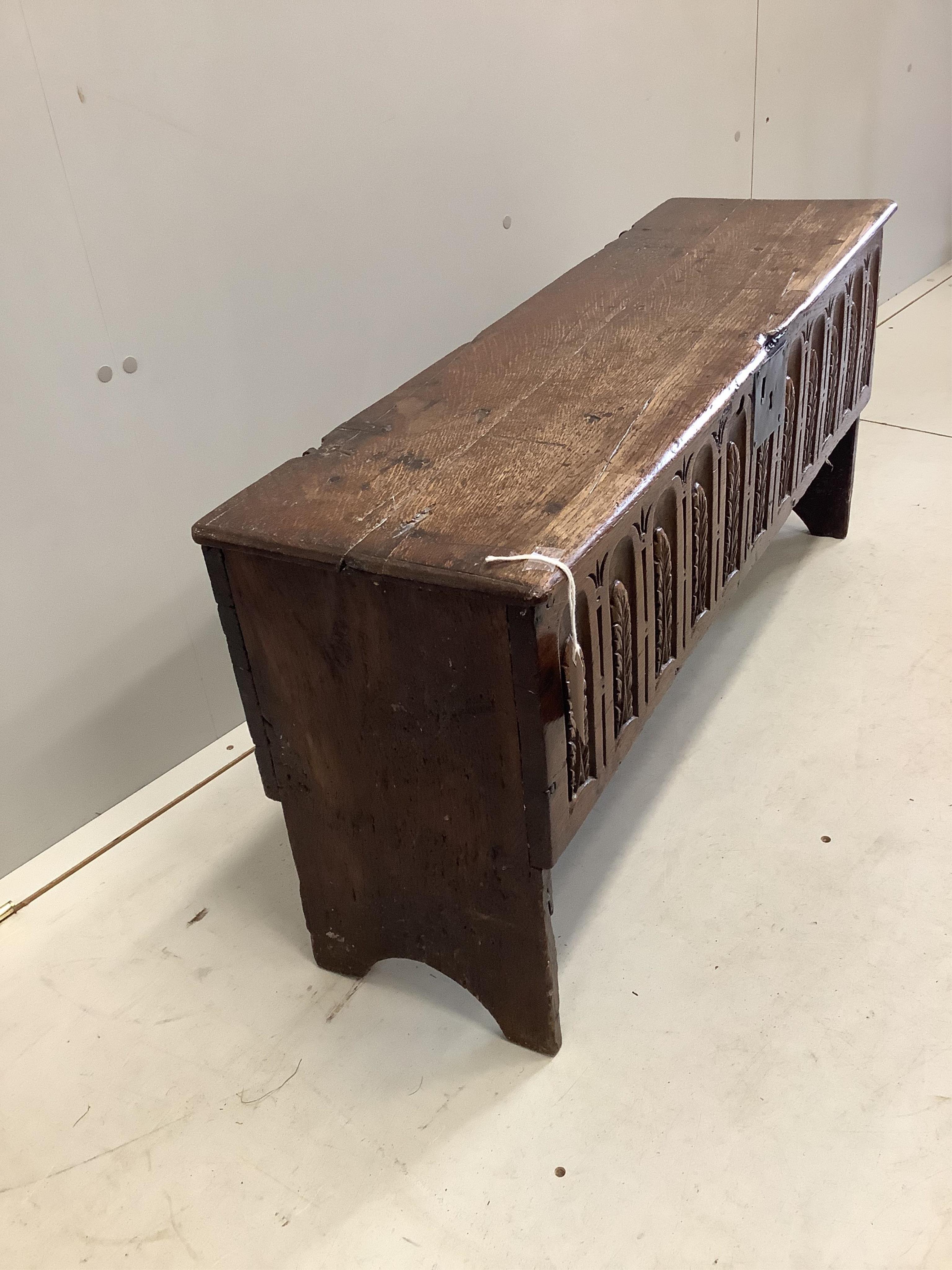 A late 17th century style carved oak six plank coffer, width 96cm, depth 29cm, height 45cm. Condition - fair